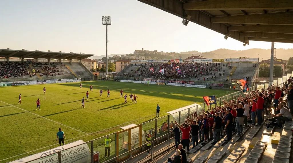 Stadio di Serie B italiano visto dalle tribune con tifosi e campo da calcio in erba naturale